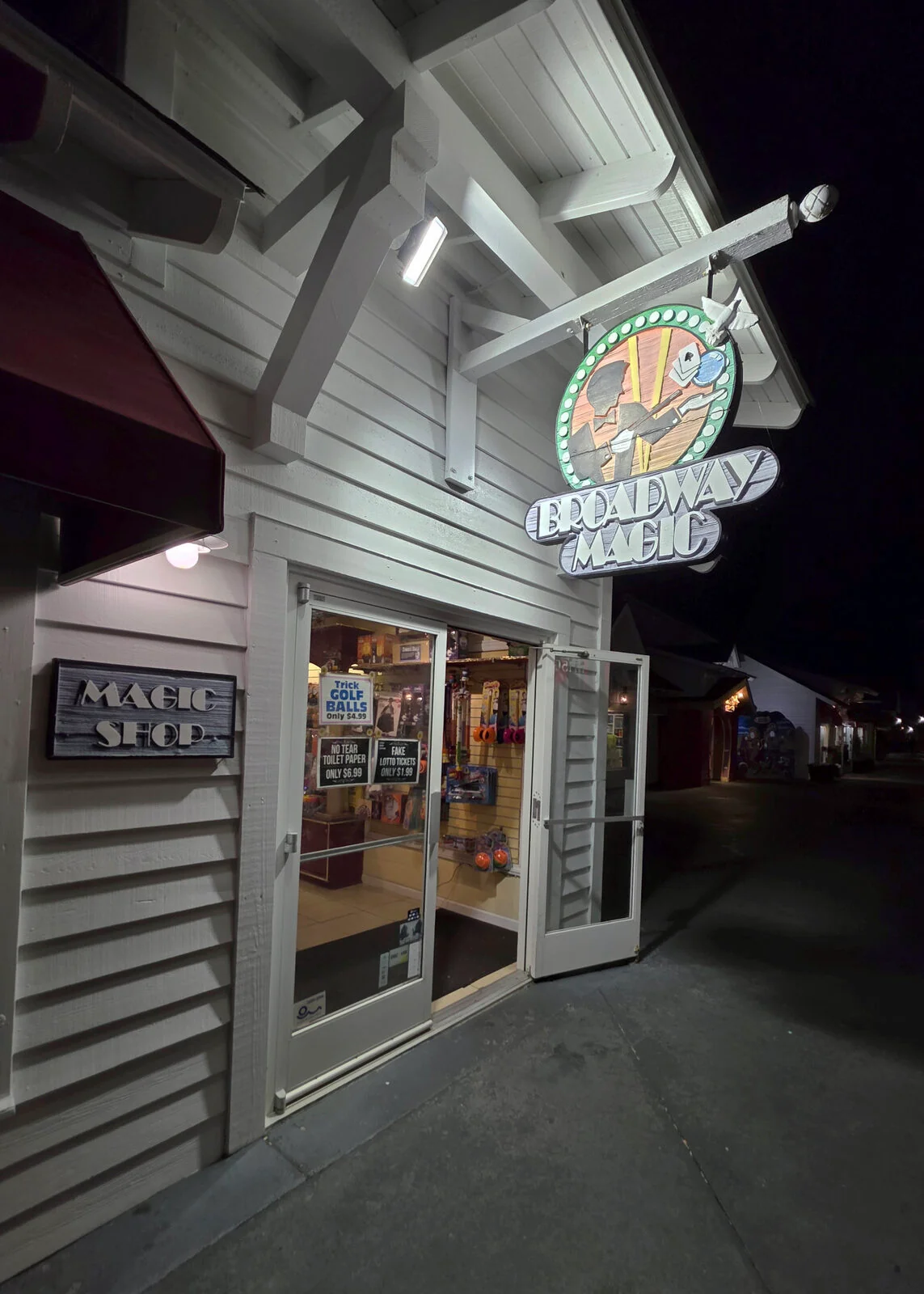 Coastal storefront entrance lit up at night